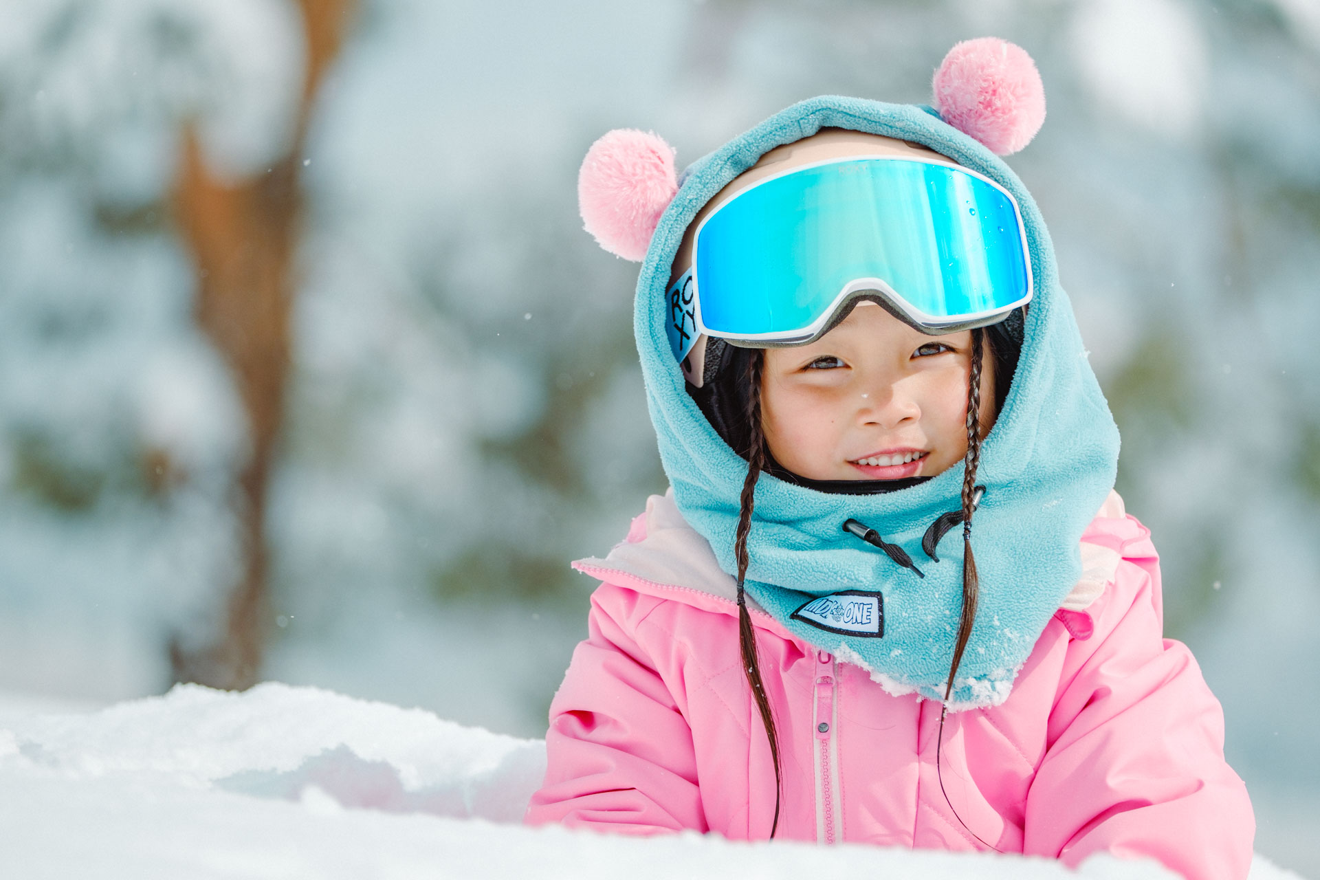 Child wearing MDXONE balaclava with PomPoms