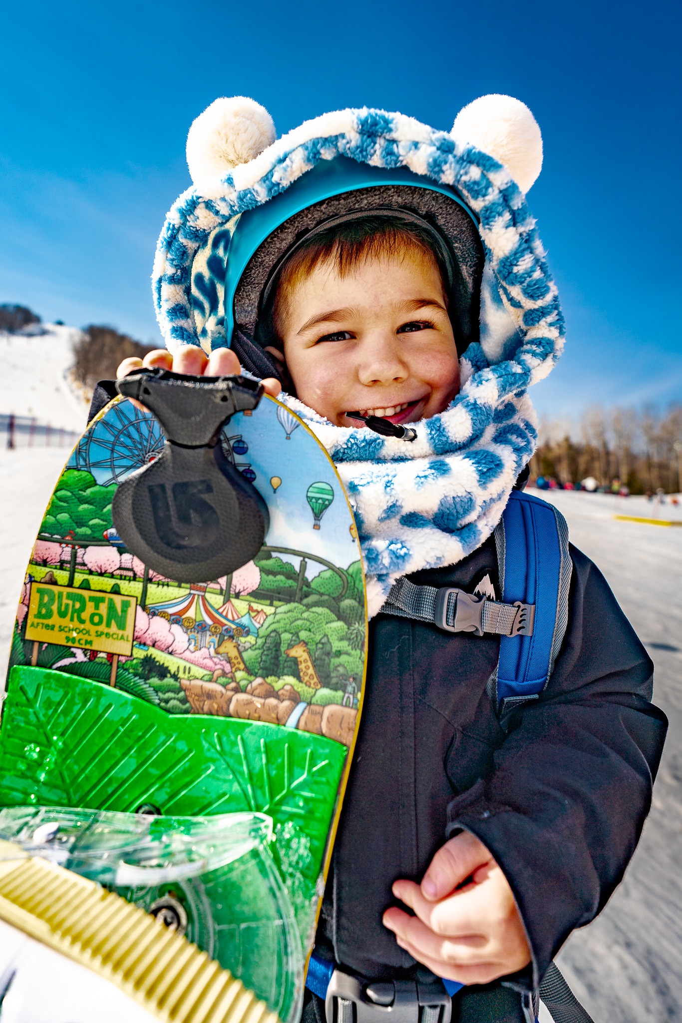Child wearing a blue and white MDXONE plush balaclava