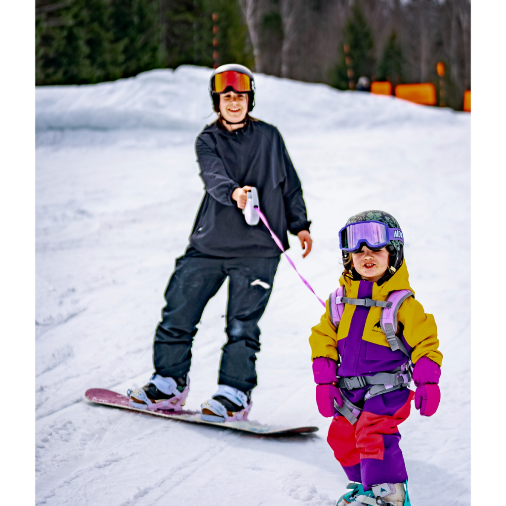 Front-facing child wearing the Lavender THEONE harness on snow